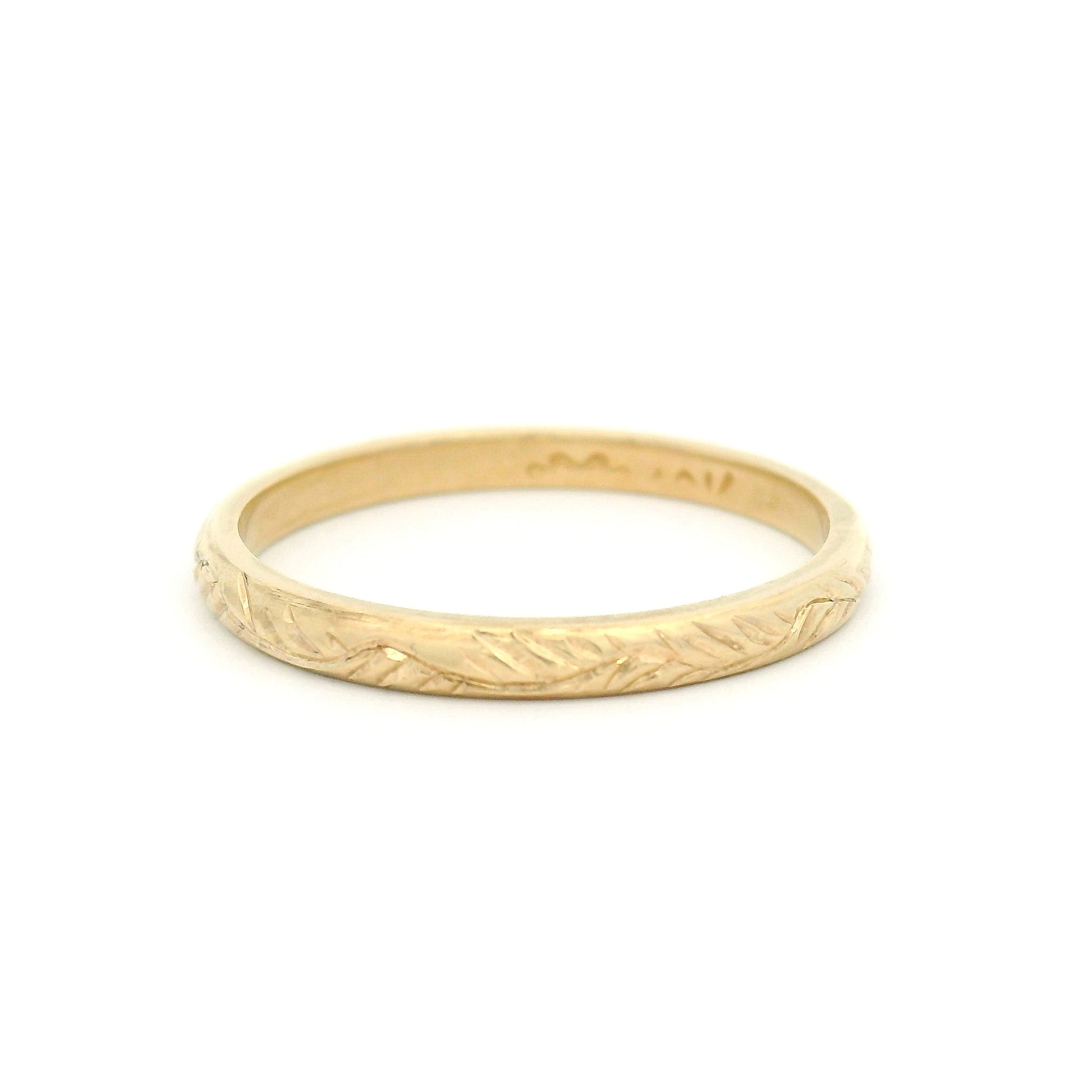 10K yellow gold 2mm soft dome profile band with hand-engraved vine pattern and detailed textured finish.