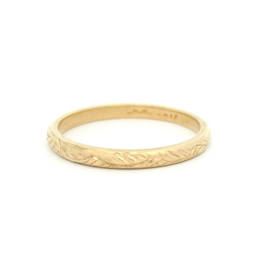 10K yellow gold 2mm soft dome profile band with hand-engraved vine pattern and detailed textured finish.