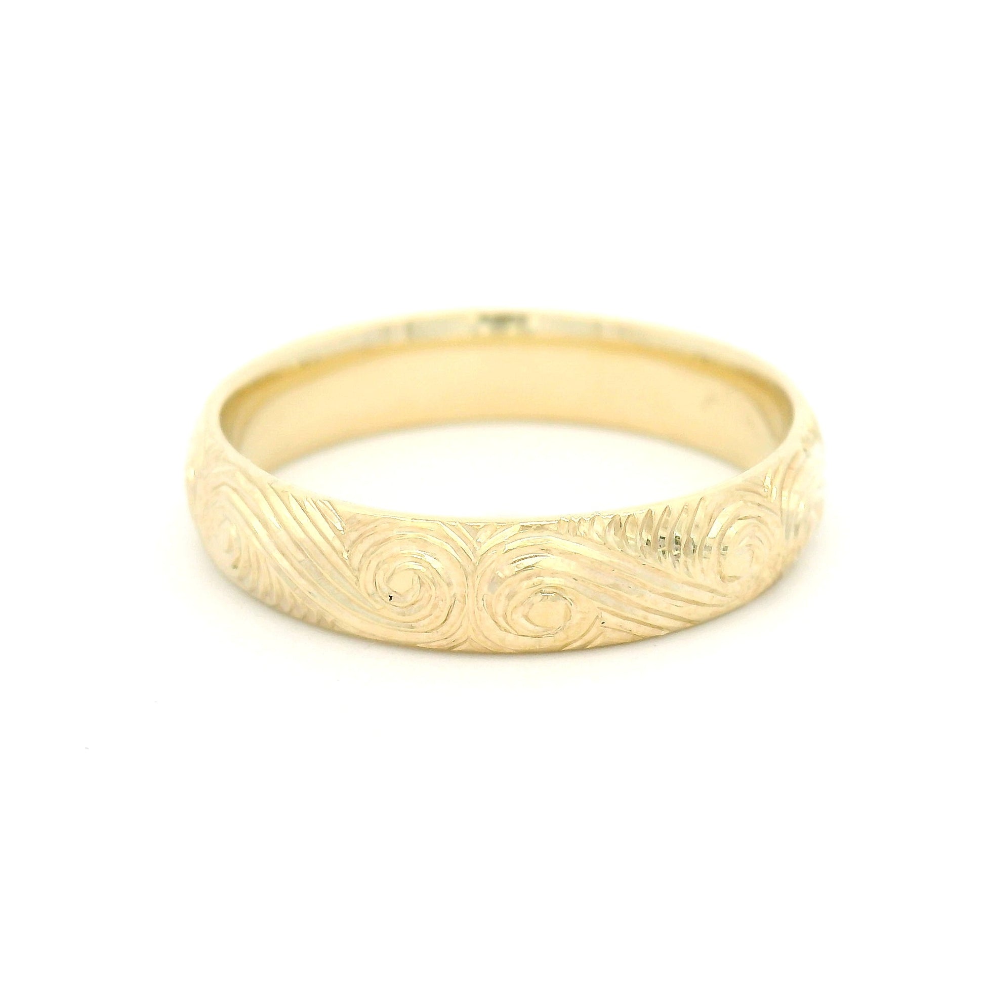 10K yellow gold 4mm soft domed band with hand-engraved ocean wave pattern and textured finish.