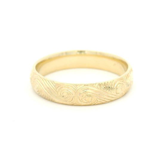 10K yellow gold 4mm soft domed band with hand-engraved ocean wave pattern and textured finish.