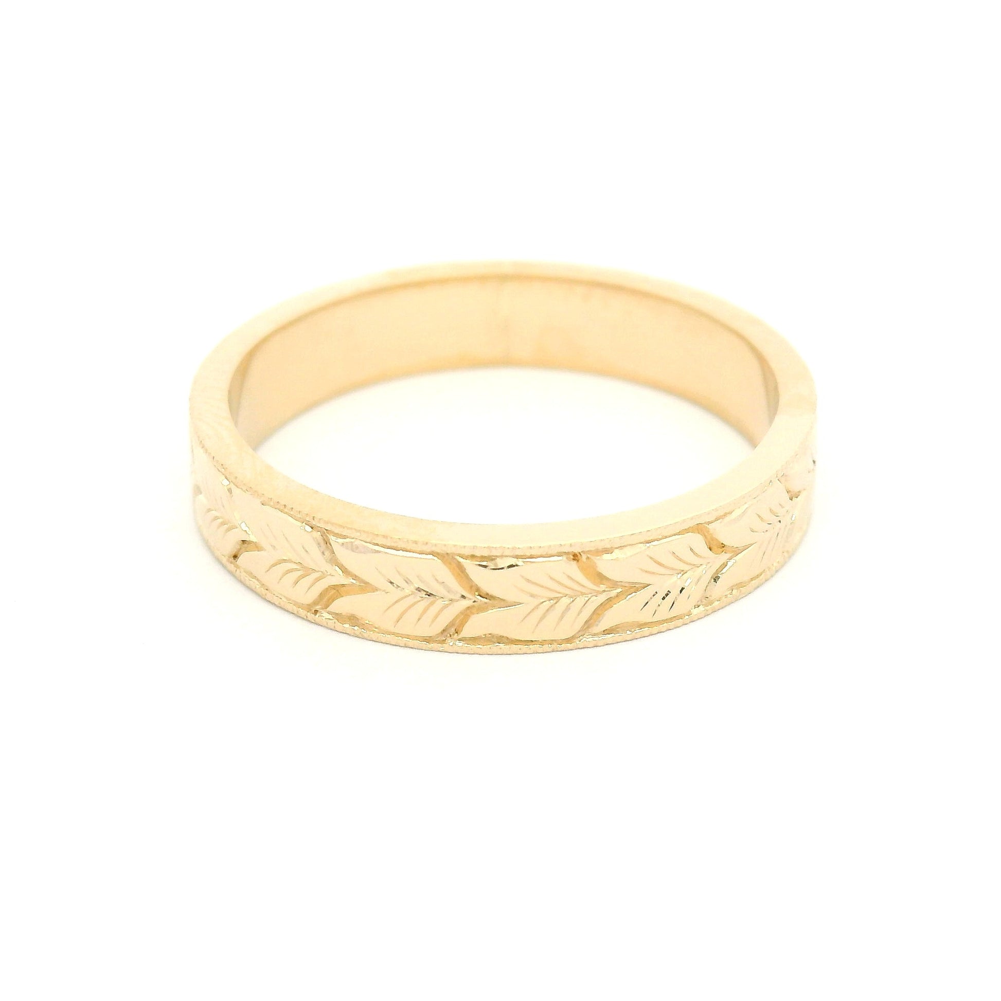 14K yellow gold 4mm flat profile band with hand-engraved aspen leaf pattern and milgrain edge detailing.
