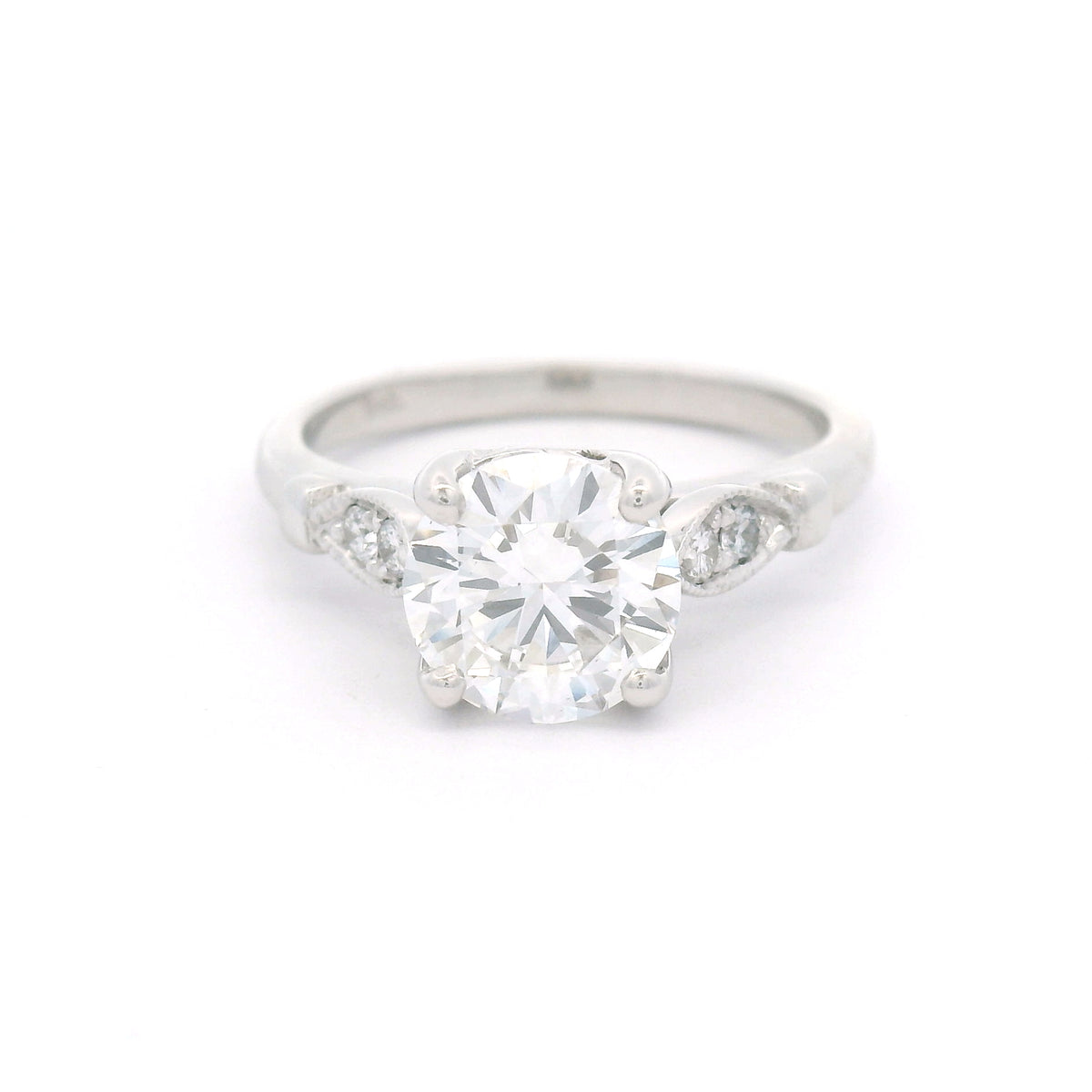 14K white gold engagement ring with a claw-set 1.50ct lab-grown round brilliant-cut diamond and four bead-set lab-grown diamond accents within milgrain-edged leaf motifs.
