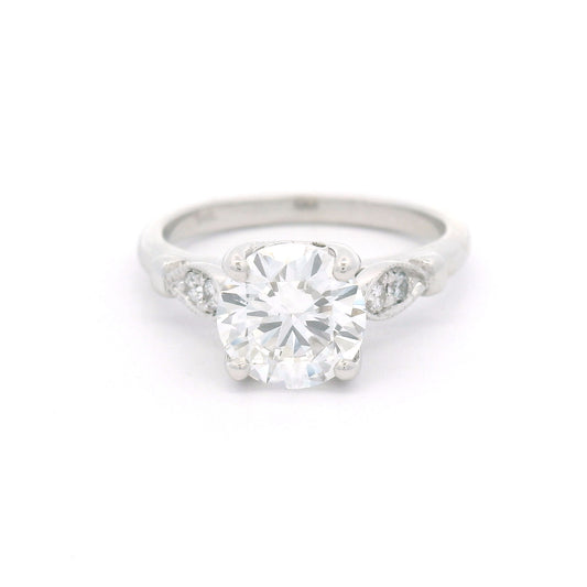 14K white gold engagement ring with a claw-set 1.50ct lab-grown round brilliant-cut diamond and four bead-set lab-grown diamond accents within milgrain-edged leaf motifs.