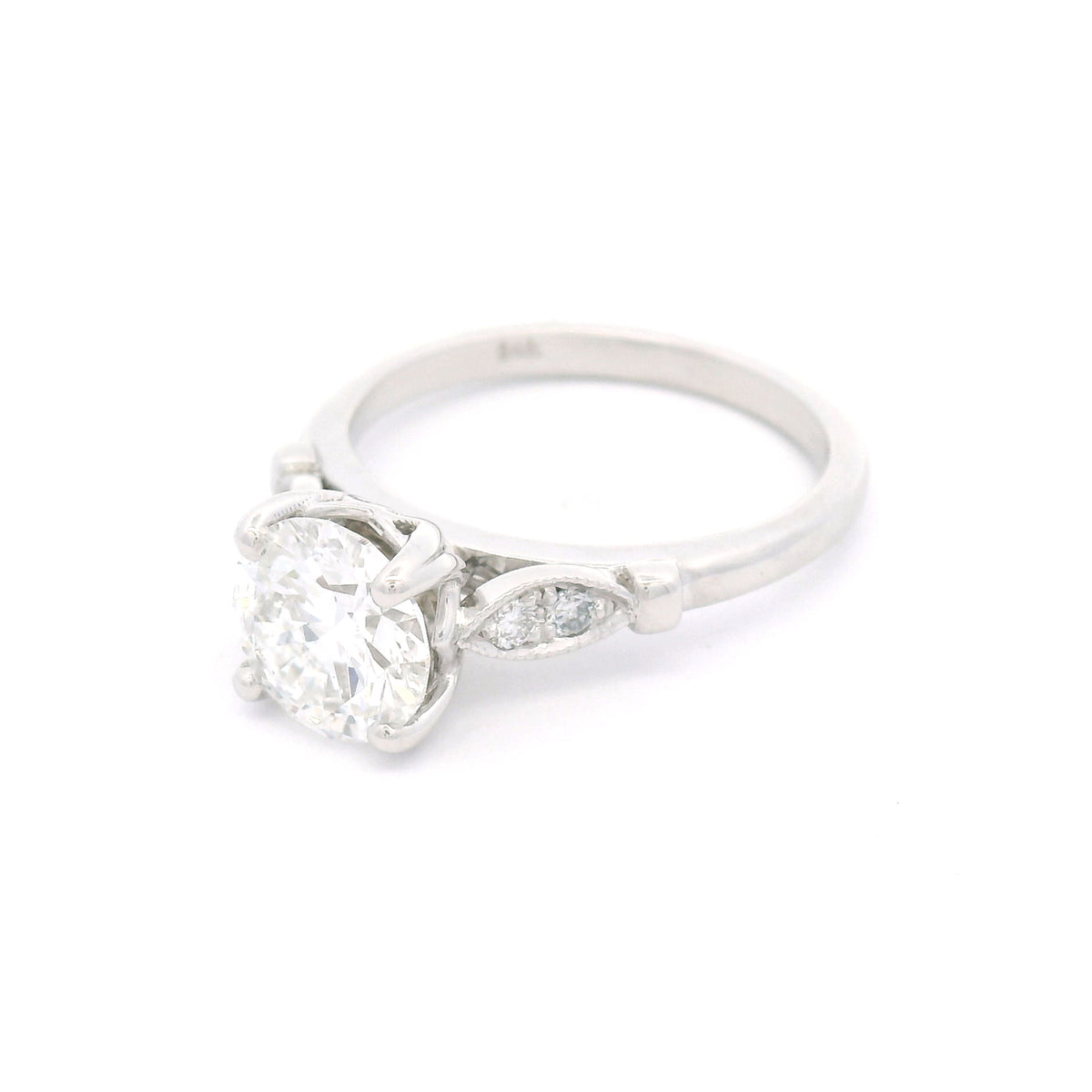 14K white gold engagement ring with a claw-set 1.50ct lab-grown round brilliant-cut diamond and four bead-set lab-grown diamond accents within milgrain-edged leaf motifs.