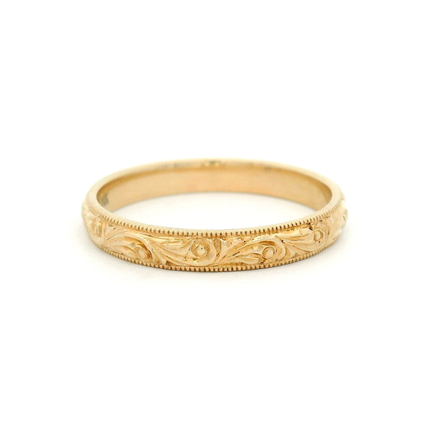 14K yellow gold 3mm wedding band featuring a hand-engraved scroll pattern and fine milgrain edges with vintage-inspired detailing.