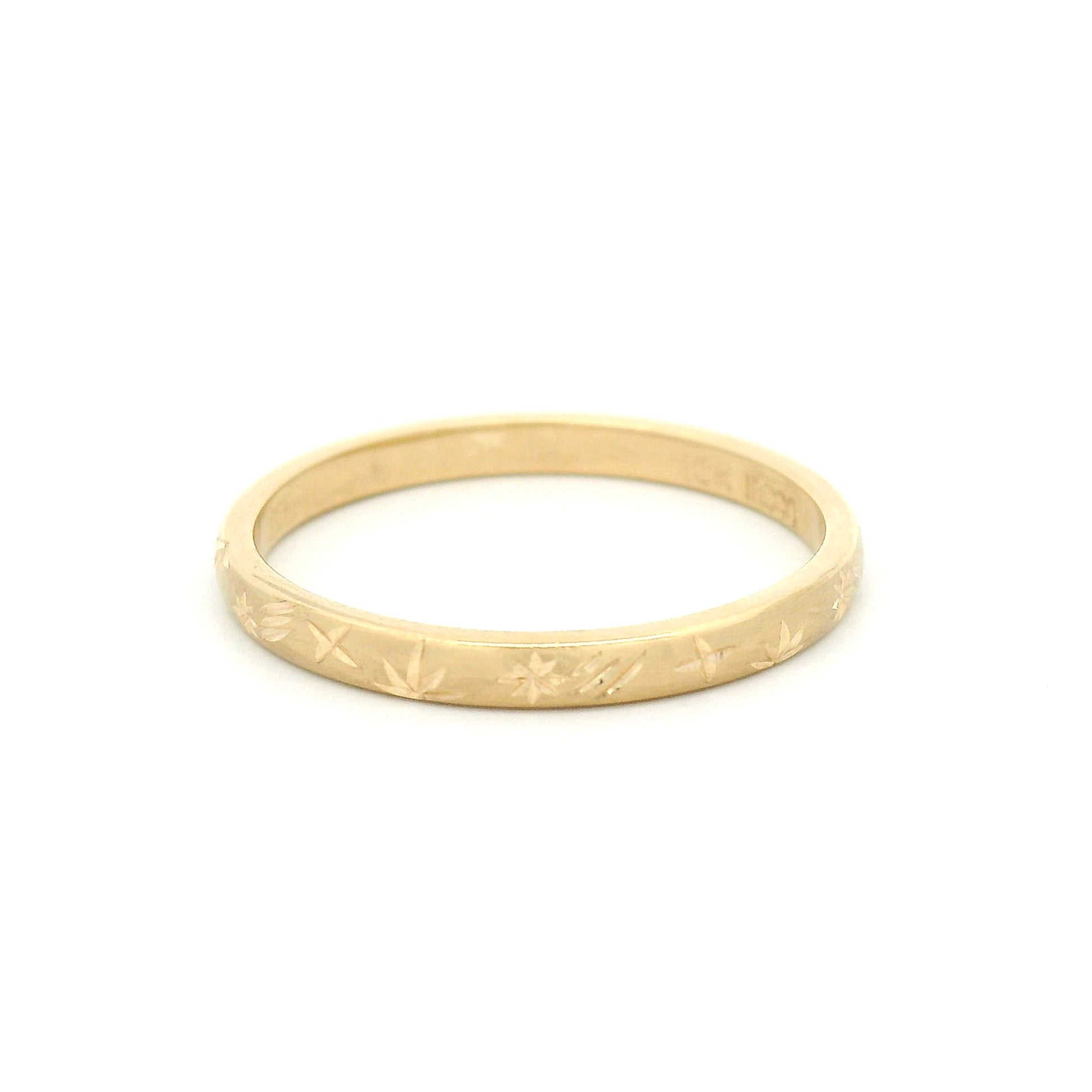 10K yellow gold 2mm soft domed wedding band featuring a hand-engraved shooting star design with celestial-inspired detailing.