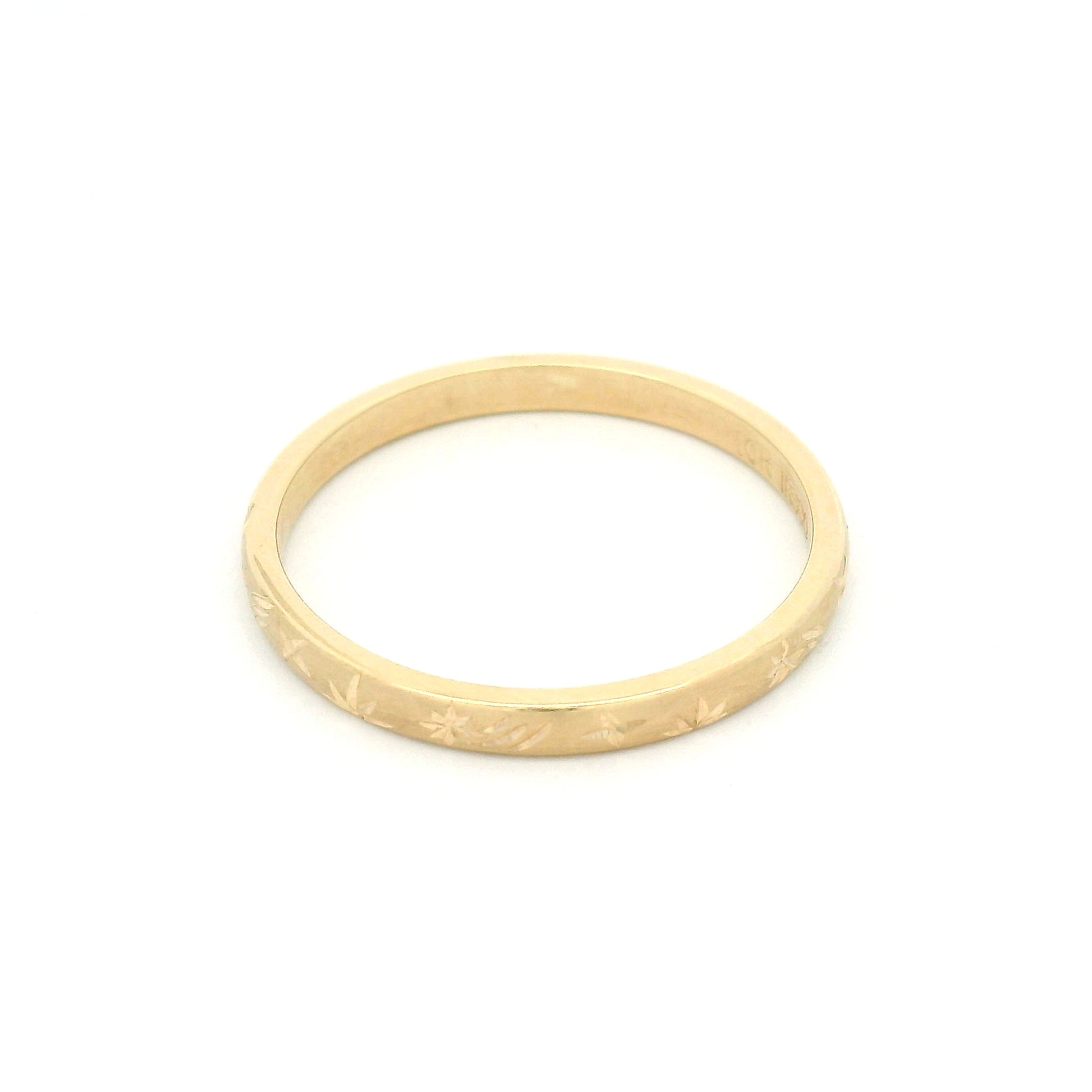 10K yellow gold 2mm soft domed wedding band featuring a hand-engraved shooting star design with celestial-inspired detailing.
