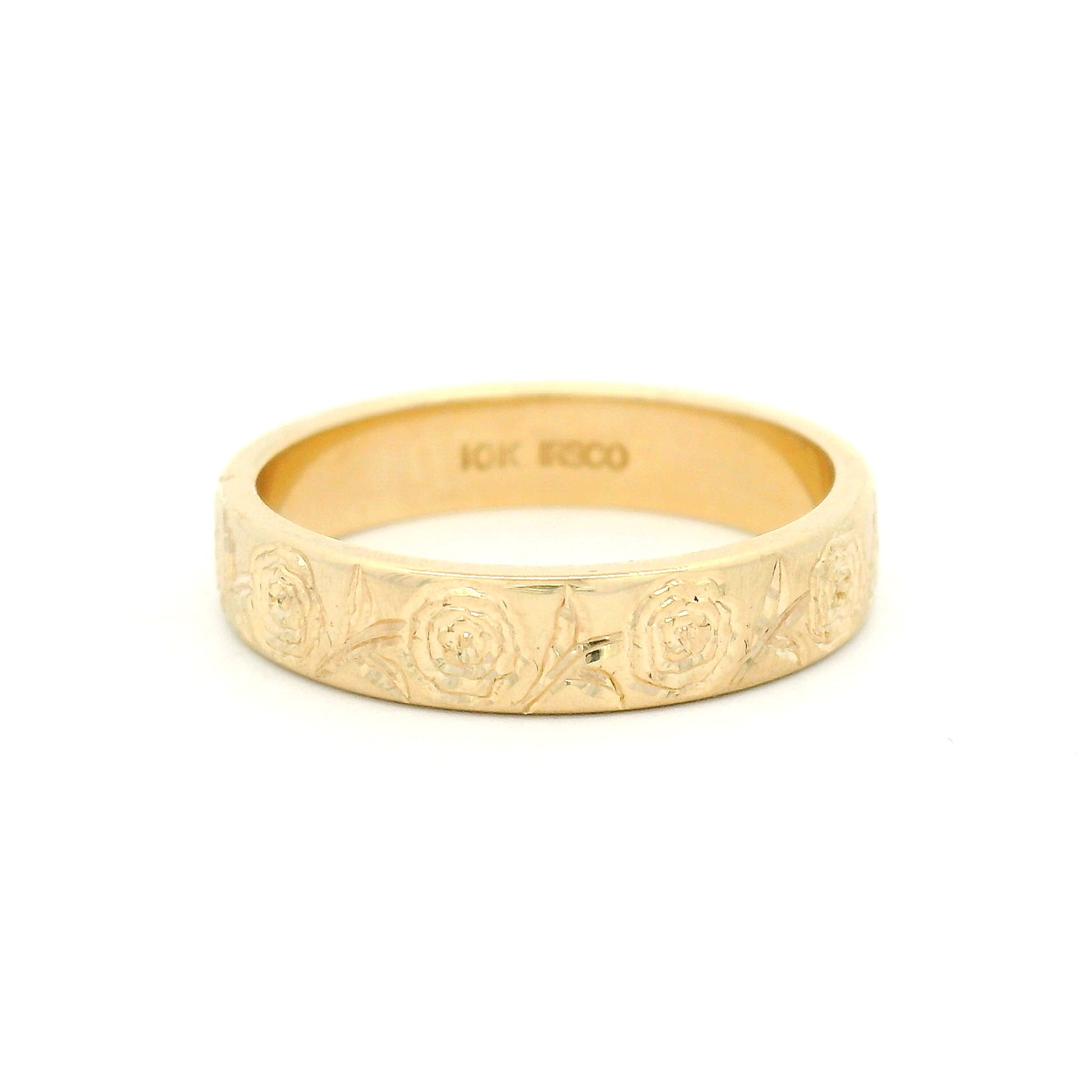 10K yellow gold 4mm soft domed wedding band with hand-engraved peony floral design covering two-thirds of the band.