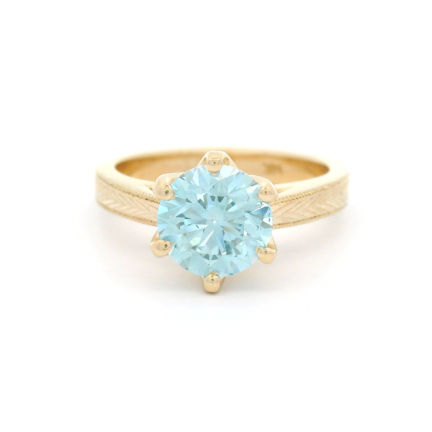 14K yellow gold solitaire engagement ring featuring a claw-set 1.63ct lab-grown round brilliant-cut Fancy Intense Blue-Green diamond with hand-engraved wheat patterns on each side.