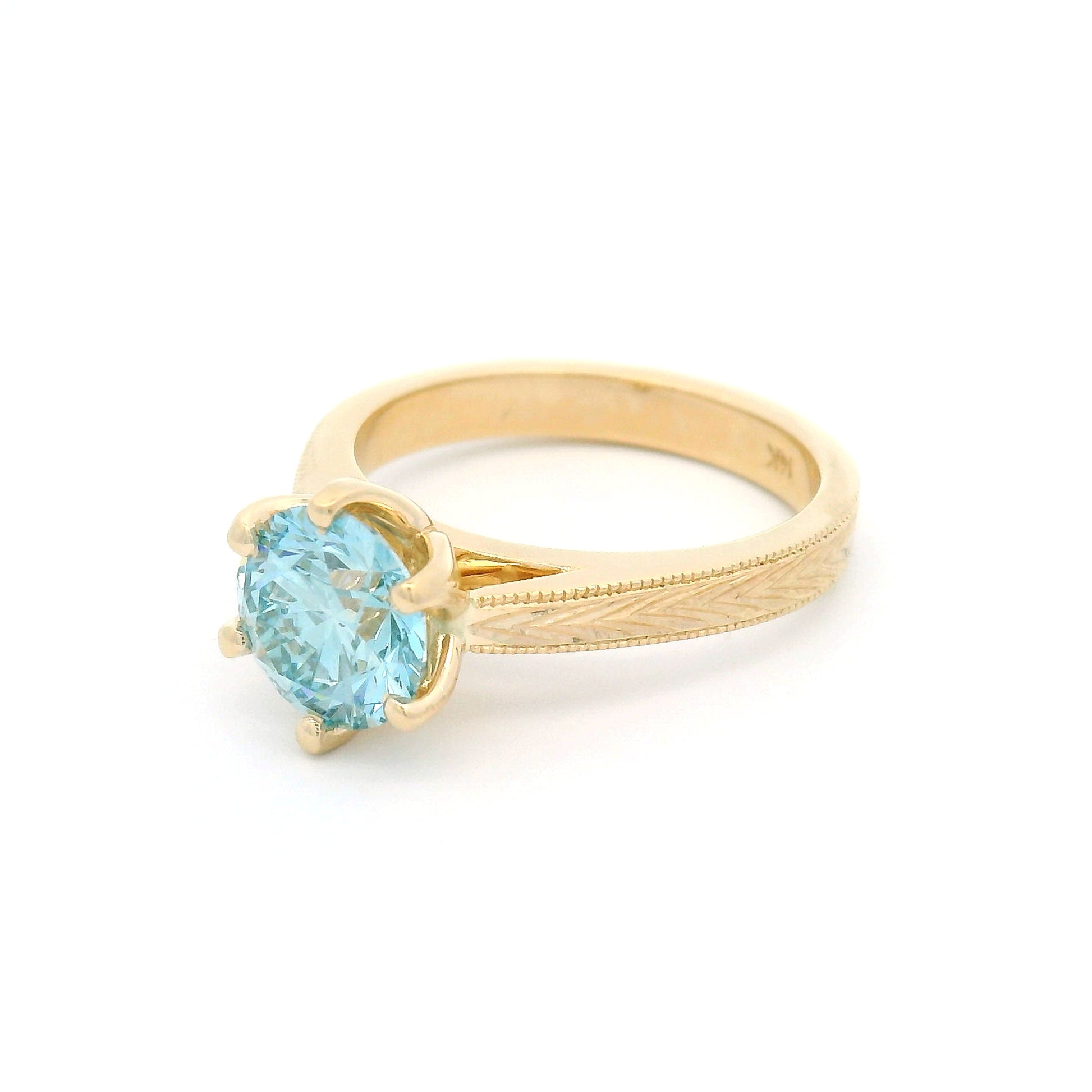 14K yellow gold solitaire engagement ring featuring a claw-set 1.63ct lab-grown round brilliant-cut Fancy Intense Blue-Green diamond with hand-engraved wheat patterns on each side.