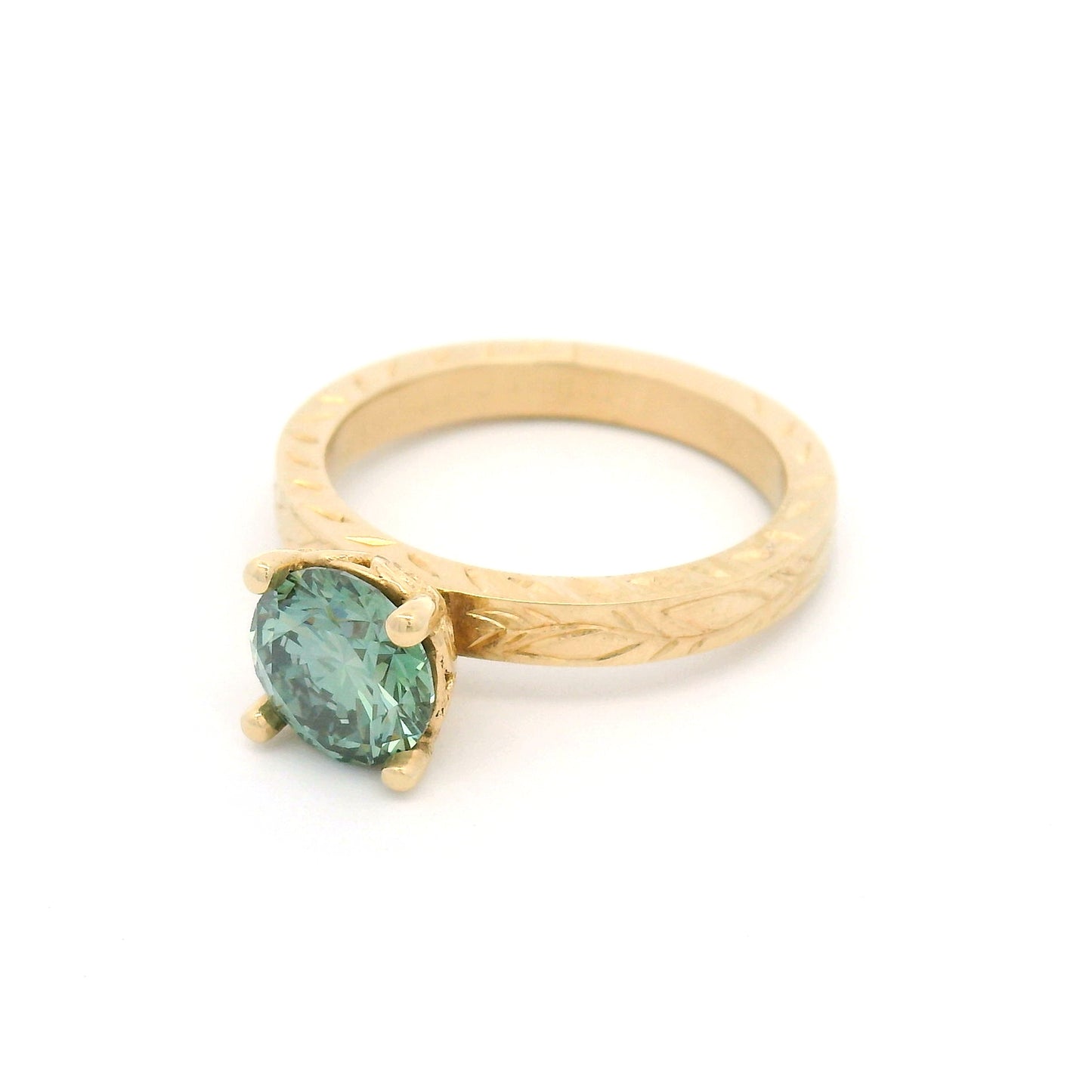 14K yellow gold solitaire engagement ring with 1.3ct lab-grown round brilliant Fancy Green diamond and hand-engraved vine and leaf pattern band.