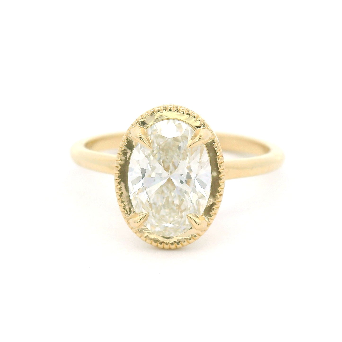 14K yellow gold solitaire engagement ring featuring a claw-set 1.54ct lab-grown oval brilliant-cut diamond with VVS2 clarity, H colour, and a delicate milgrain-edged setting.
