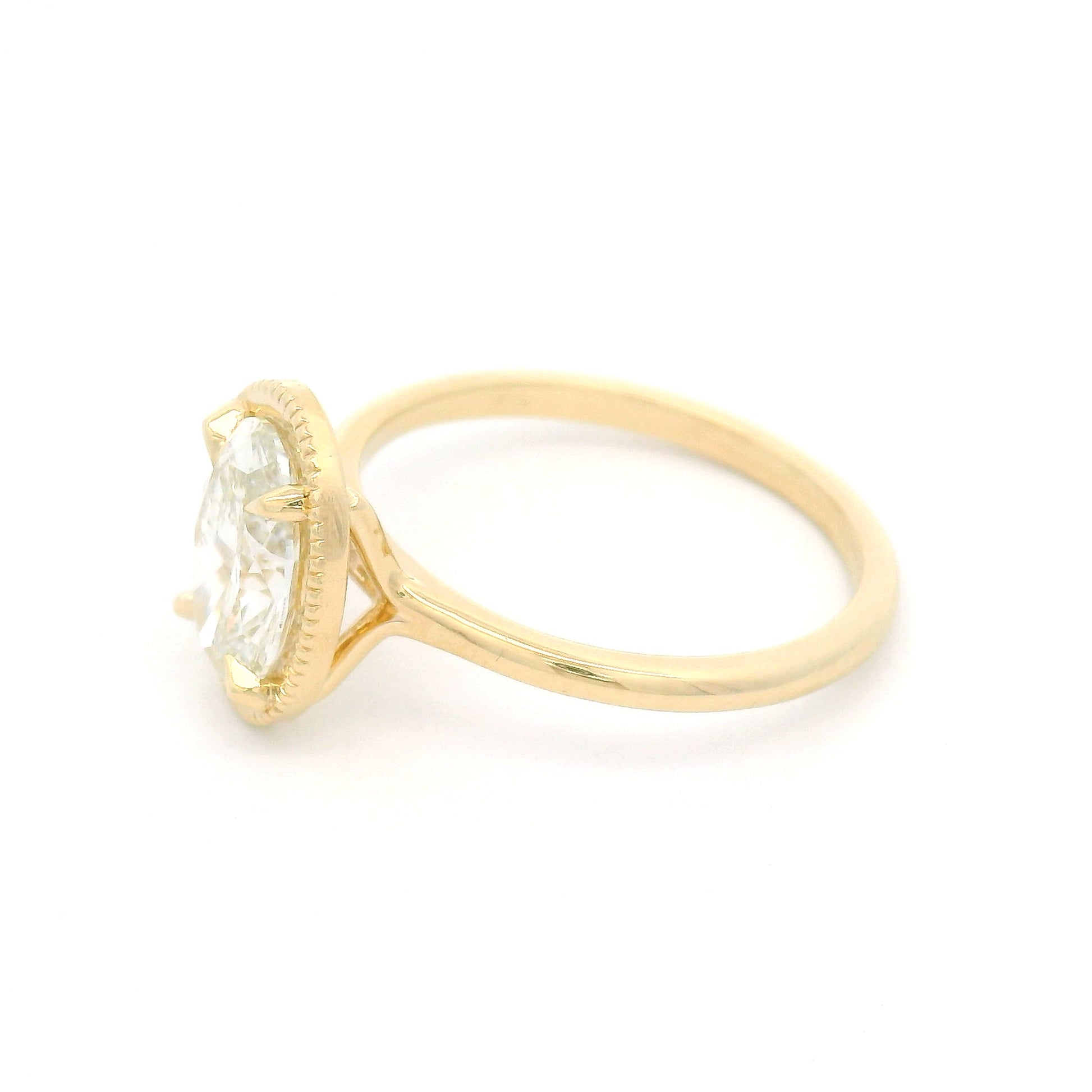 14K yellow gold solitaire engagement ring featuring a claw-set 1.54ct lab-grown oval brilliant-cut diamond with VVS2 clarity, H colour, and a delicate milgrain-edged setting.