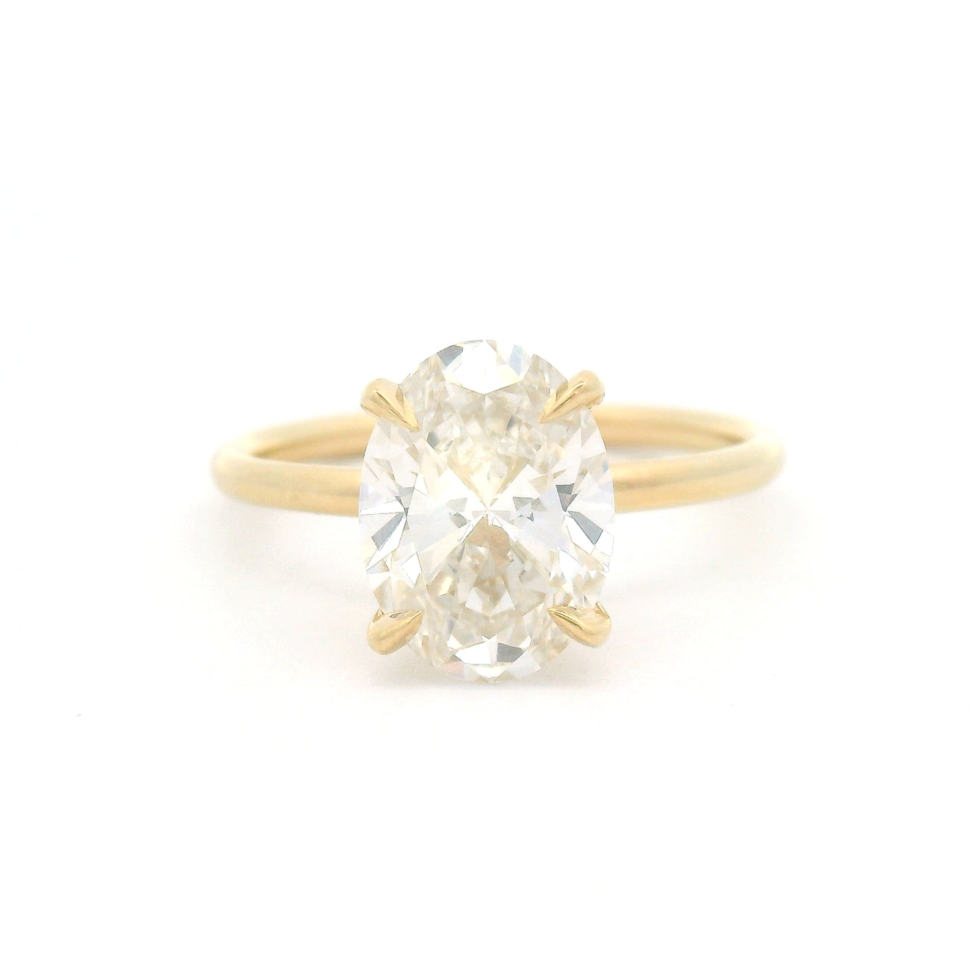14K yellow gold solitaire engagement ring featuring a GIA certified 2.27ct lab-grown oval diamond in a claw setting on a delicate 1.7mm round wire band.