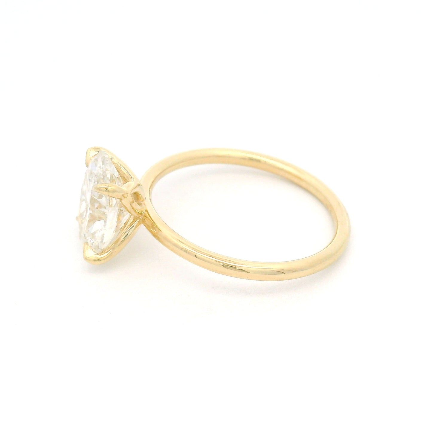 14K yellow gold solitaire engagement ring featuring a GIA certified 2.27ct lab-grown oval diamond in a claw setting on a delicate 1.7mm round wire band.