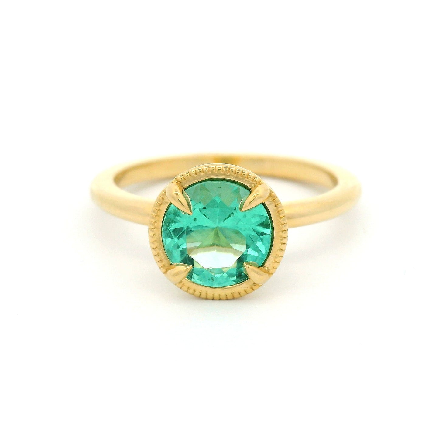 18K yellow gold solitaire ring featuring a 0.98ct round green beryl in a 4-claw setting with milgrain-framed detail on a slim band.