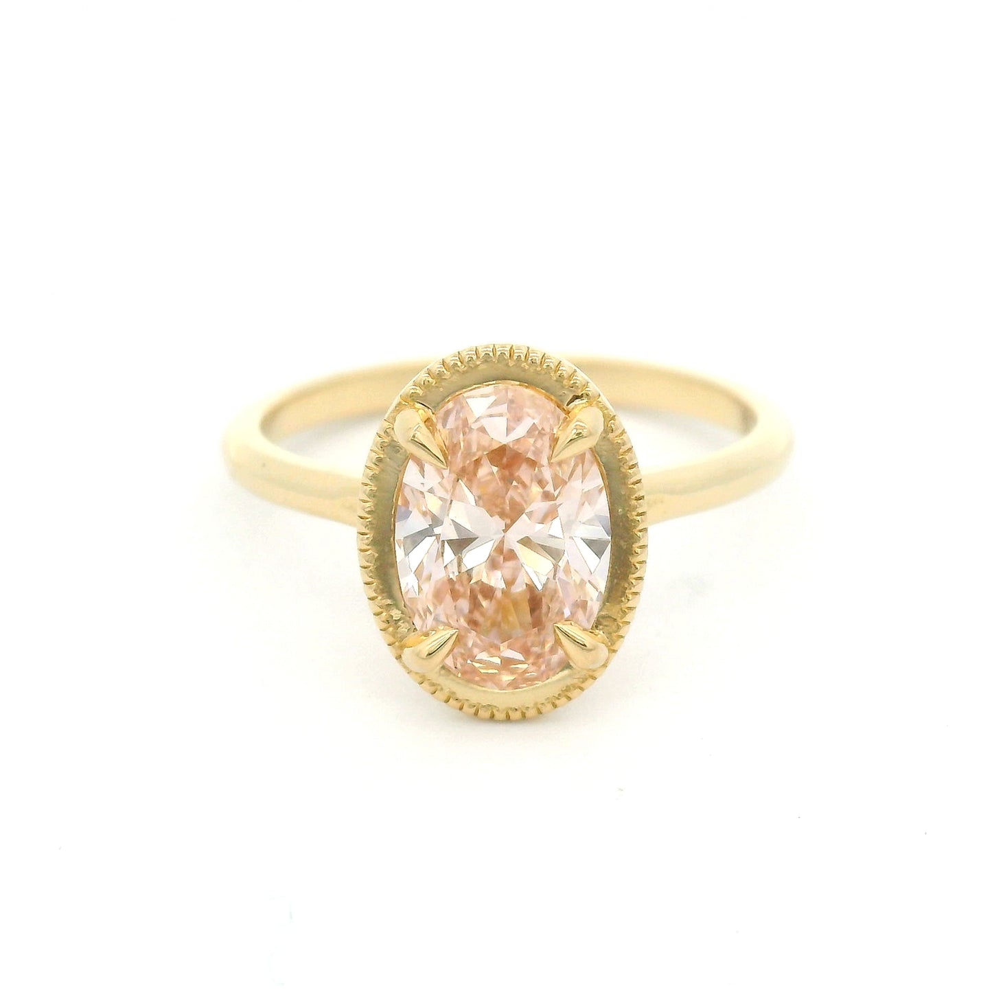 14K yellow gold solitaire engagement ring featuring a 1.50ct lab-grown oval-cut pink diamond in four-claw setting with milgrain edge and 1.8mm band.