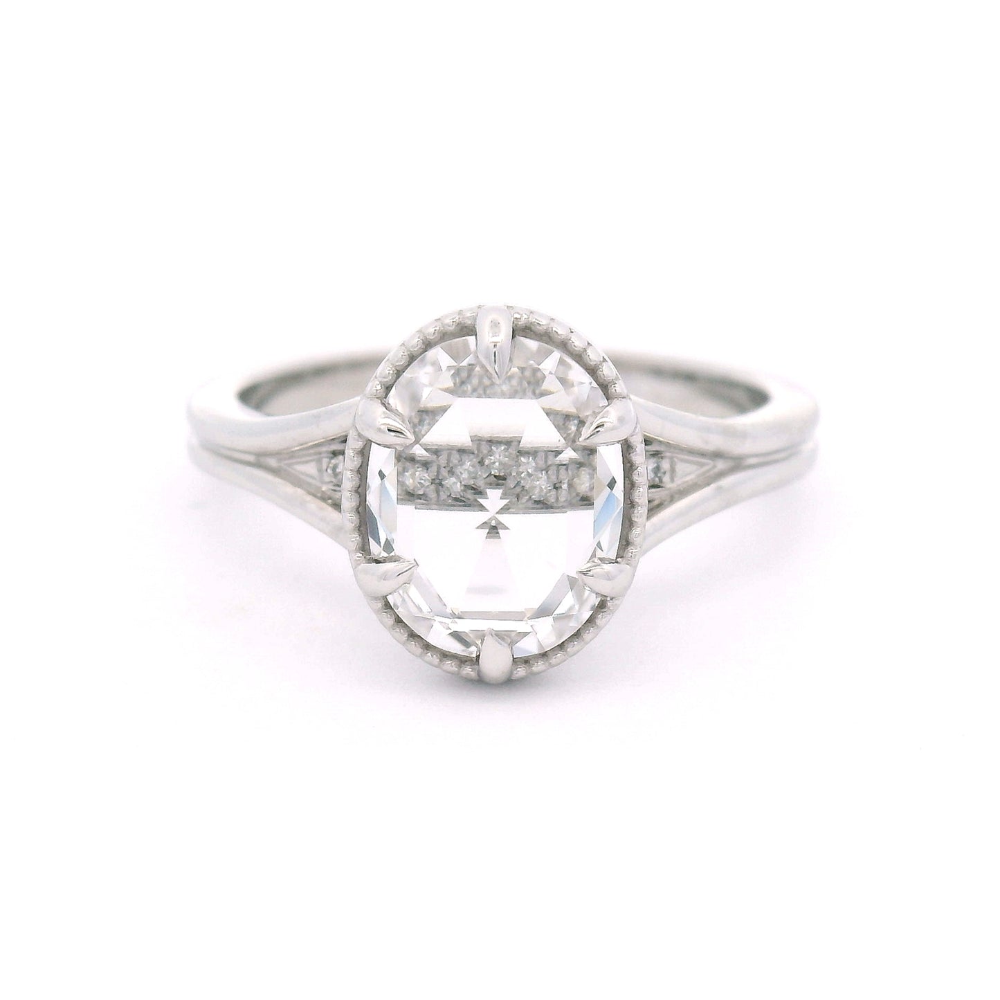 14K white gold engagement ring featuring a 2.01ct lab-grown rose-cut oval white sapphire with hidden bead-set lab-grown diamond accents in the gallery.