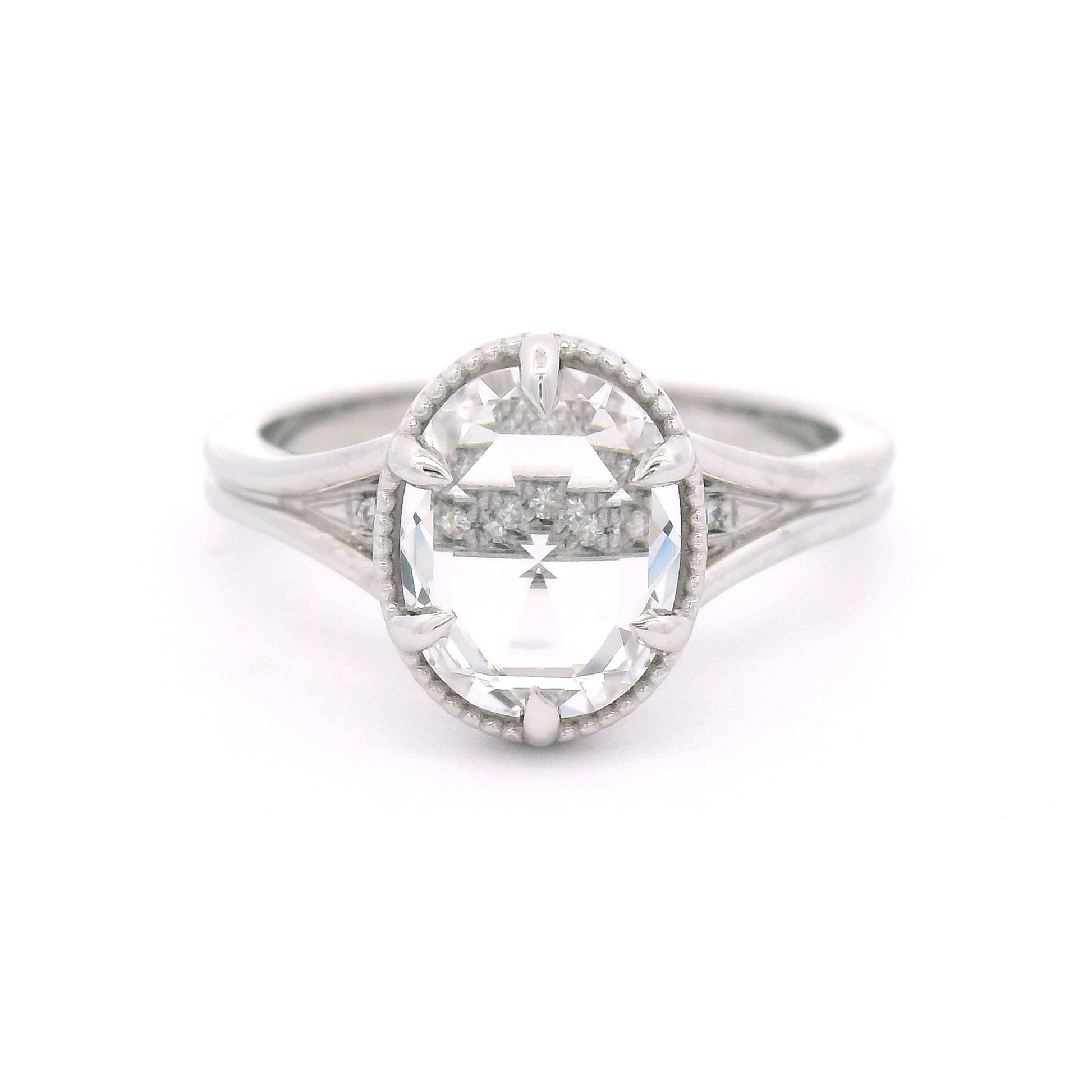 14K white gold engagement ring featuring a 2.01ct lab-grown rose-cut oval white sapphire with hidden bead-set lab-grown diamond accents in the gallery.
