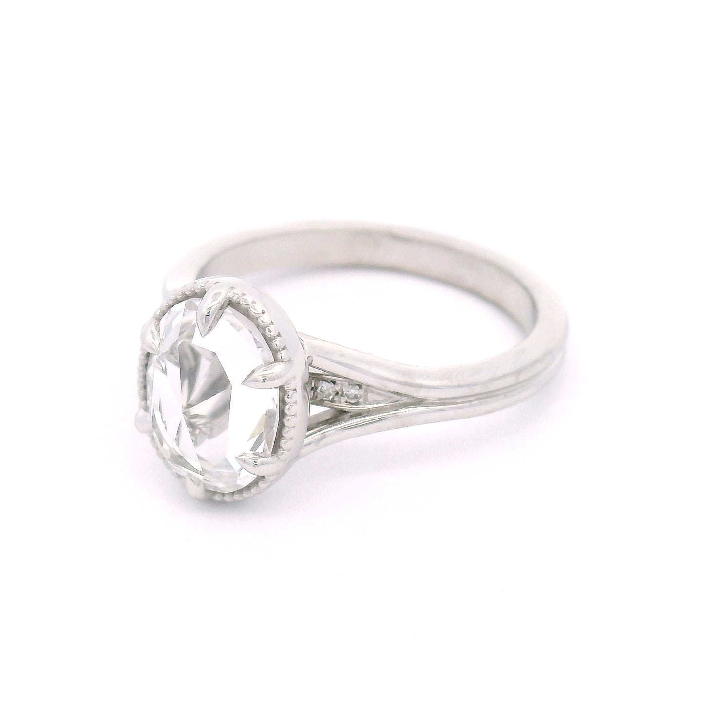 14K white gold engagement ring featuring a 2.01ct lab-grown rose-cut oval white sapphire with hidden bead-set lab-grown diamond accents in the gallery.