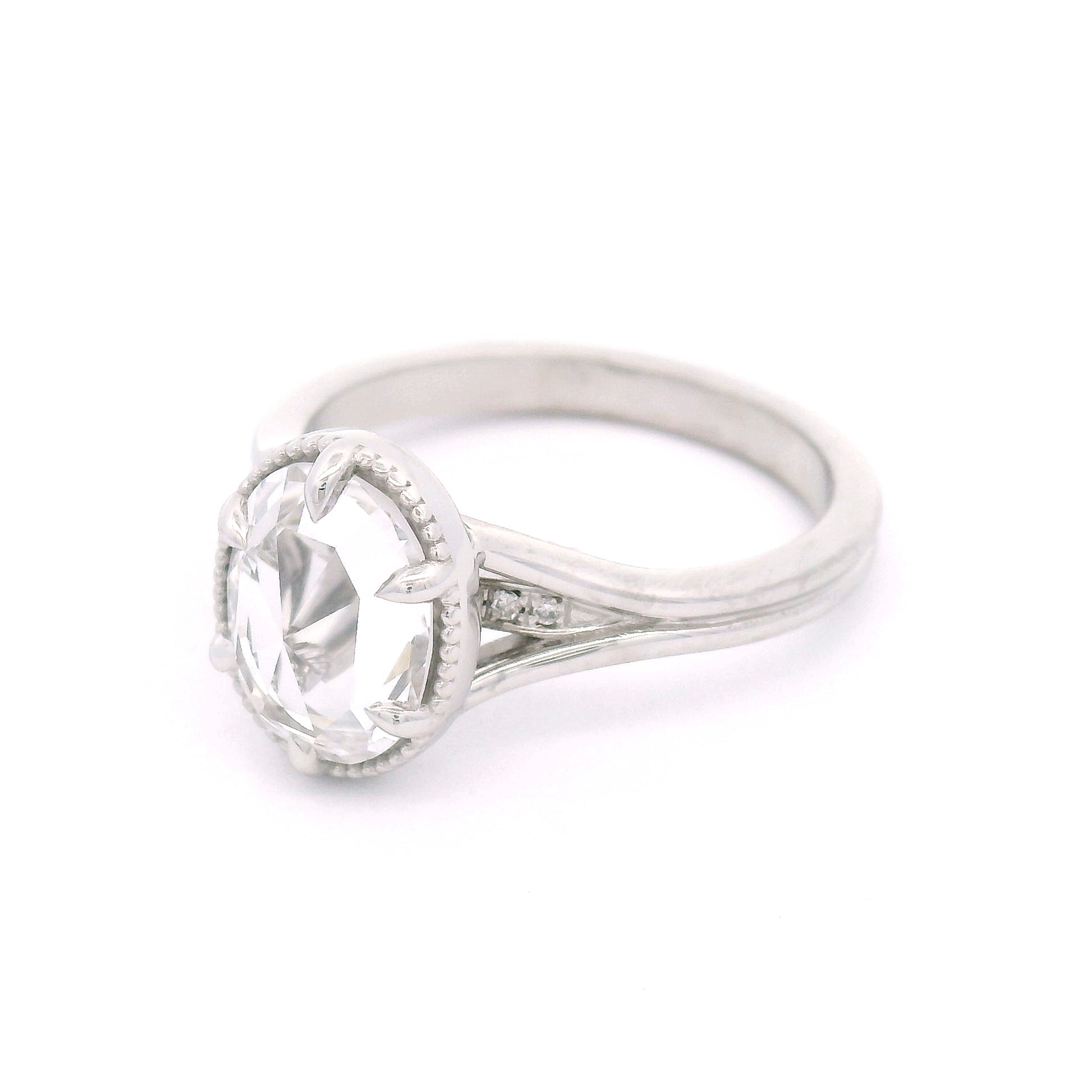 14K white gold engagement ring featuring a 2.01ct lab-grown rose-cut oval white sapphire with hidden bead-set lab-grown diamond accents in the gallery.