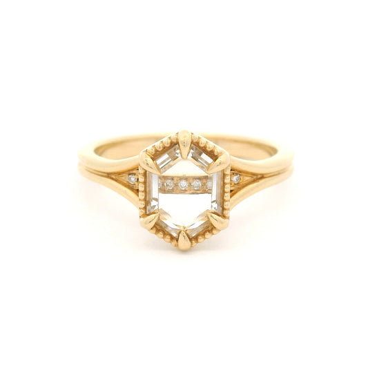 14K yellow gold engagement ring with a 0.82ct lab-grown step-cut hexagon white sapphire, claw setting, milgrain border and hidden diamond accents.