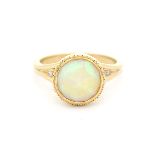 14K yellow gold engagement ring featuring a bezel-set natural 1.13ct round rose-cut opal with milgrain detail and hidden 0.06ct natural diamond accents.