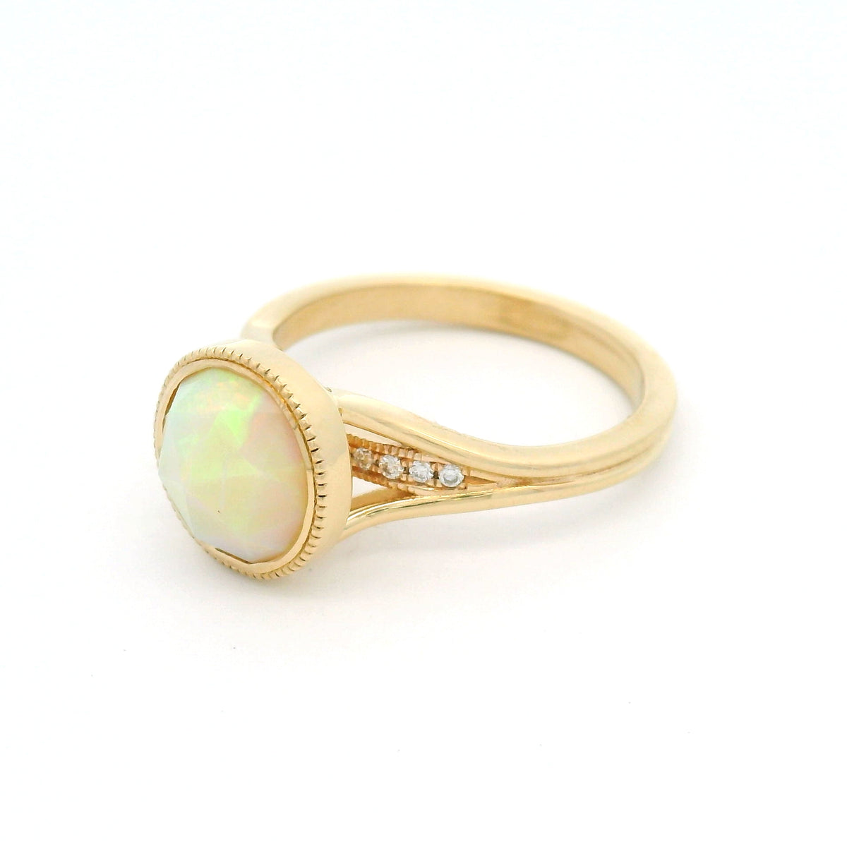 14K yellow gold engagement ring featuring a bezel-set natural 1.13ct round rose-cut opal with milgrain detail and hidden 0.06ct natural diamond accents.