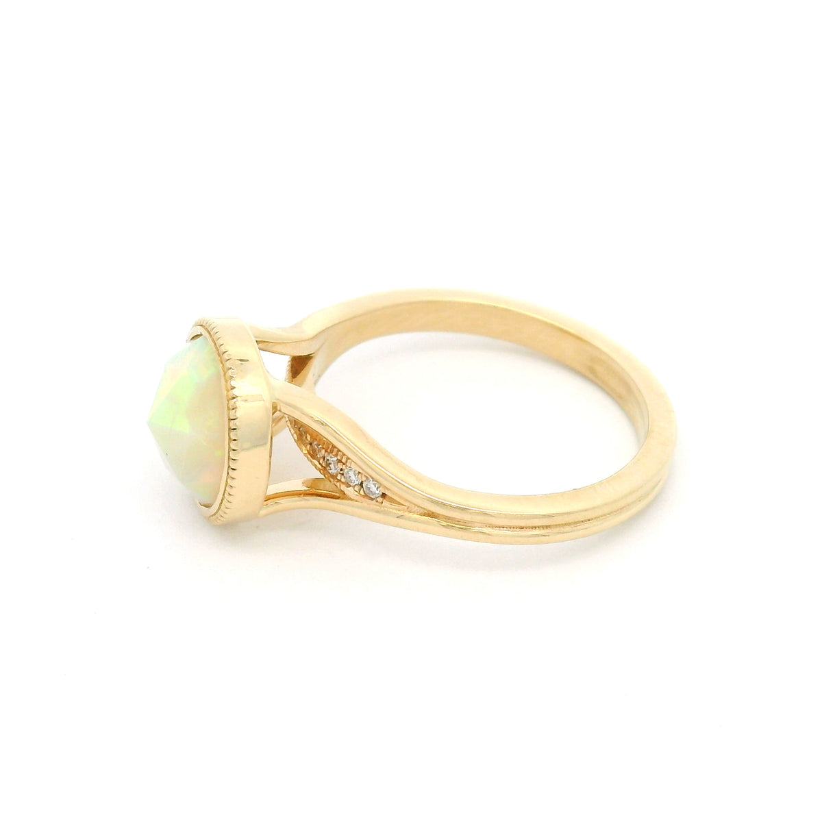 14K yellow gold engagement ring featuring a bezel-set natural 1.13ct round rose-cut opal with milgrain detail and hidden 0.06ct natural diamond accents.