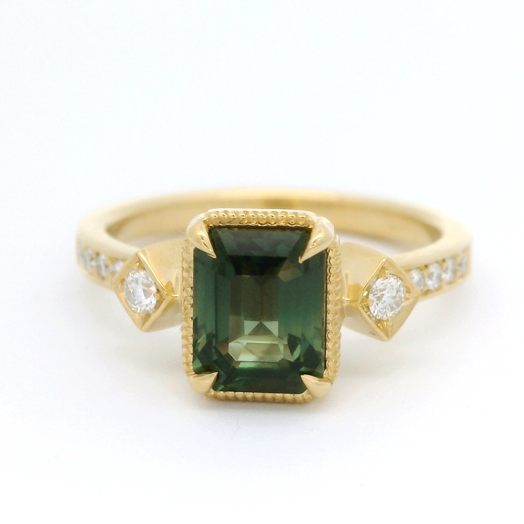 18k yellow gold ring with 1.55ct teal sapphire and accent diamonds.