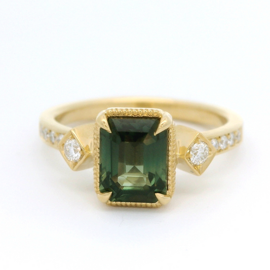 18k yellow gold ring with 1.55ct teal sapphire and accent diamonds.