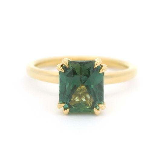 18k yellow solitaire set with a beautiful 2.10ct Teal radiant cut sapphire.