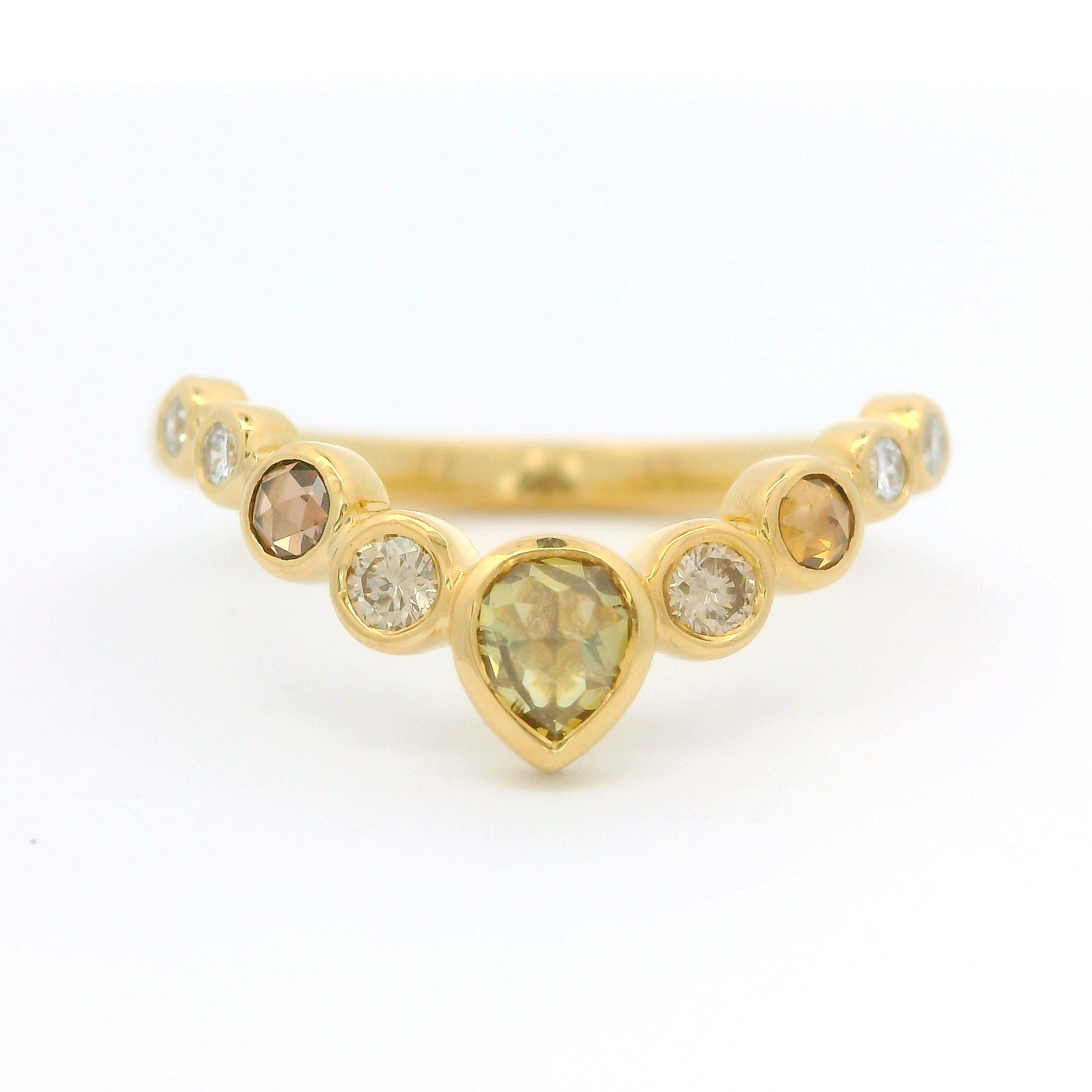 18k yellow contoured ring with nine bezel set diamonds including a stunning green rose cut diamond.