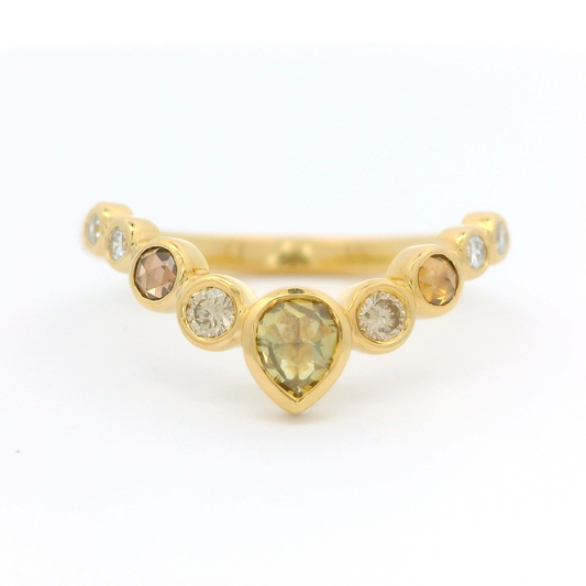18k yellow contoured ring with nine bezel set diamonds including a stunning green rose cut diamond.
