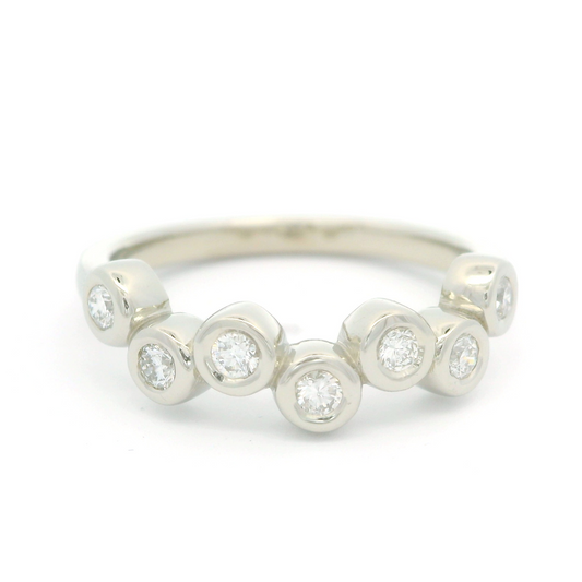 14k white band with seven bezel set diamonds.