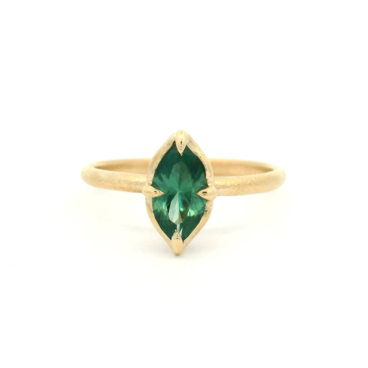 10K yellow gold delicate organic solitaire engagement ring with a claw-set 1.00ct lab-grown marquise green sapphire.