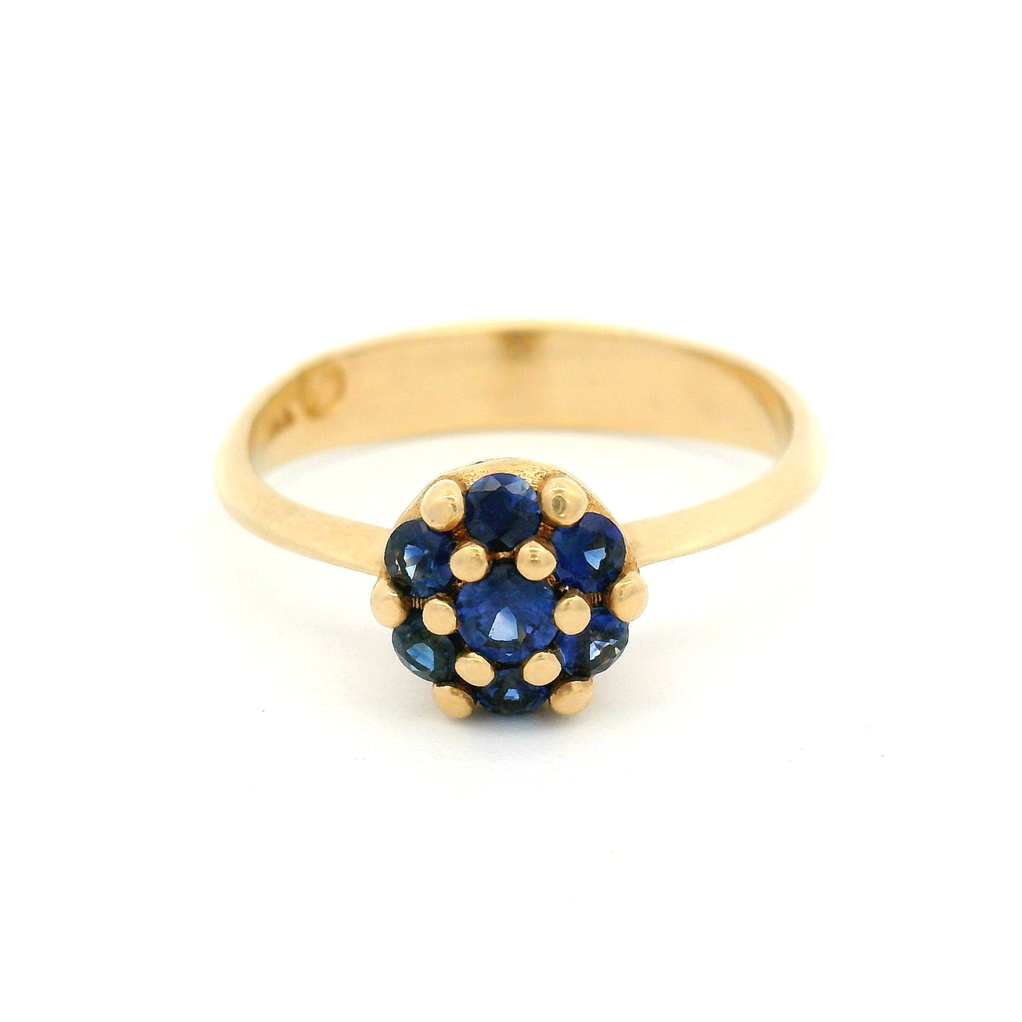 14K yellow gold engagement ring with a cluster of seven claw-set round blue sapphires measuring just over 7mm.