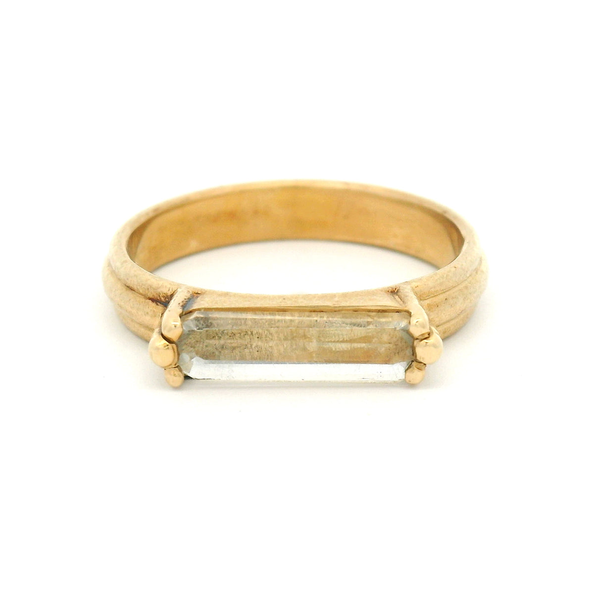 10K yellow gold rustic solitaire ring with a 1.4ct natural lozenge-cut white sapphire in a six-claw setting.