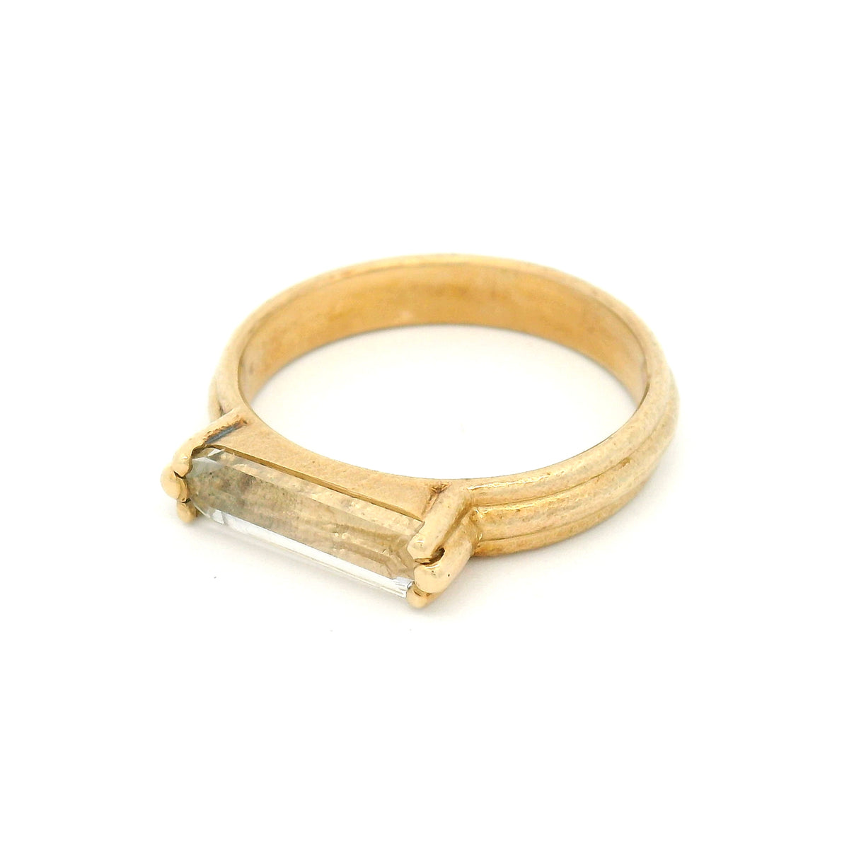 10K yellow gold rustic solitaire ring with a 1.4ct natural lozenge-cut white sapphire in a six-claw setting.