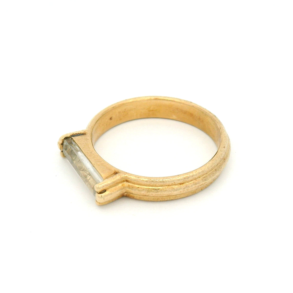 10K yellow gold rustic solitaire ring with a 1.4ct natural lozenge-cut white sapphire in a six-claw setting.