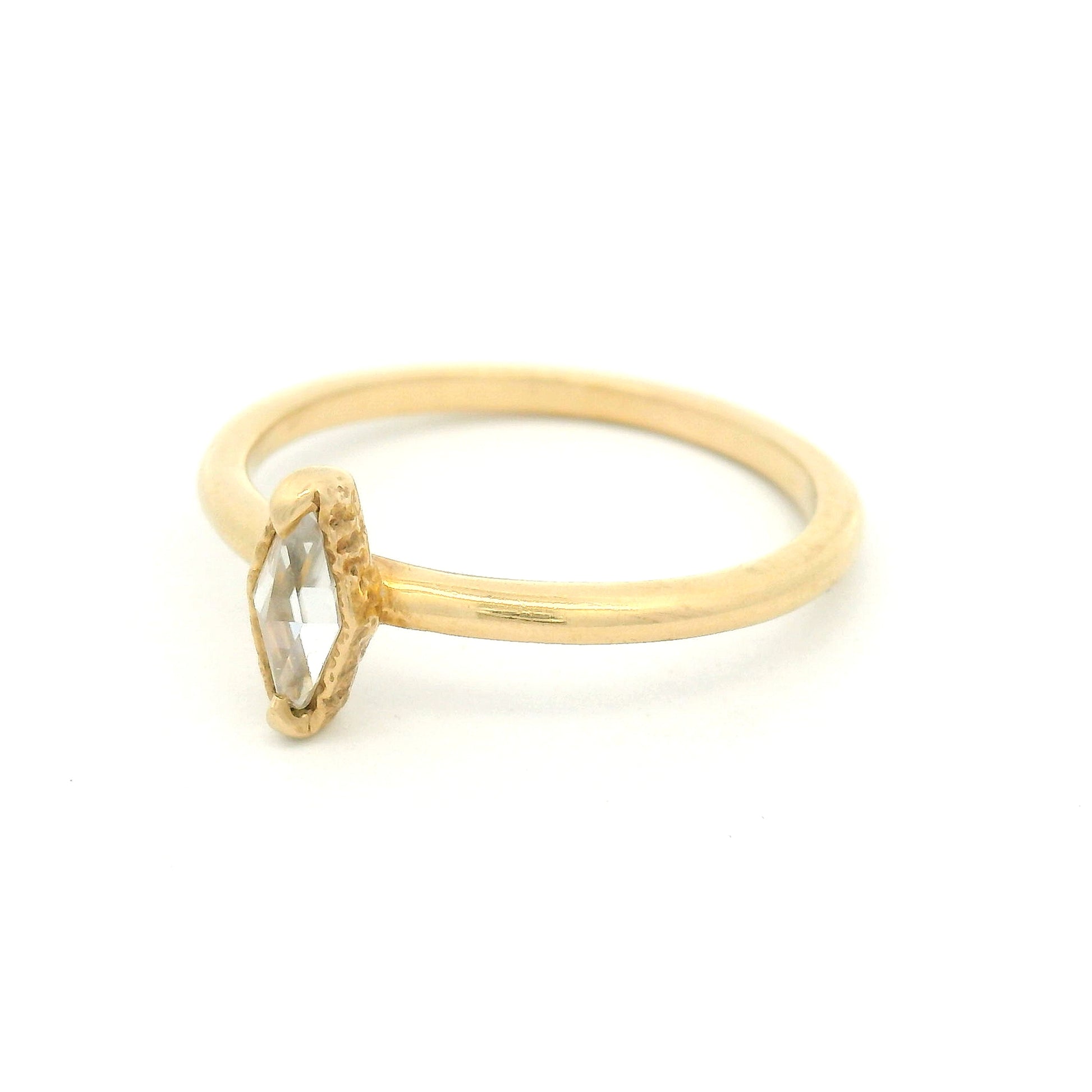14K yellow gold solitaire ring featuring a 0.15ct diamond-shaped rose-cut moissanite, organic textured gallery, and polished 1.7mm soft domed band.