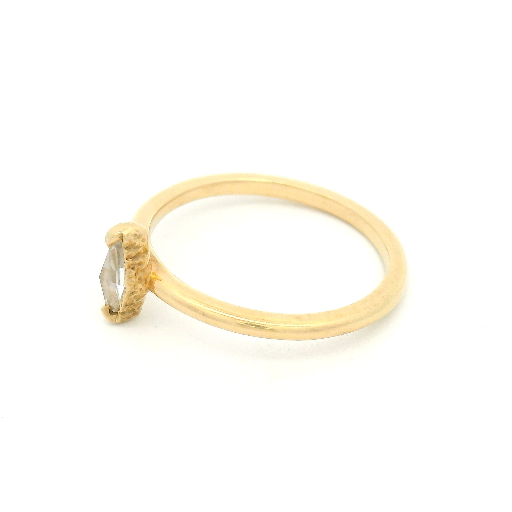 14K yellow gold solitaire ring featuring a 0.15ct diamond-shaped rose-cut moissanite, organic textured gallery, and polished 1.7mm soft domed band.