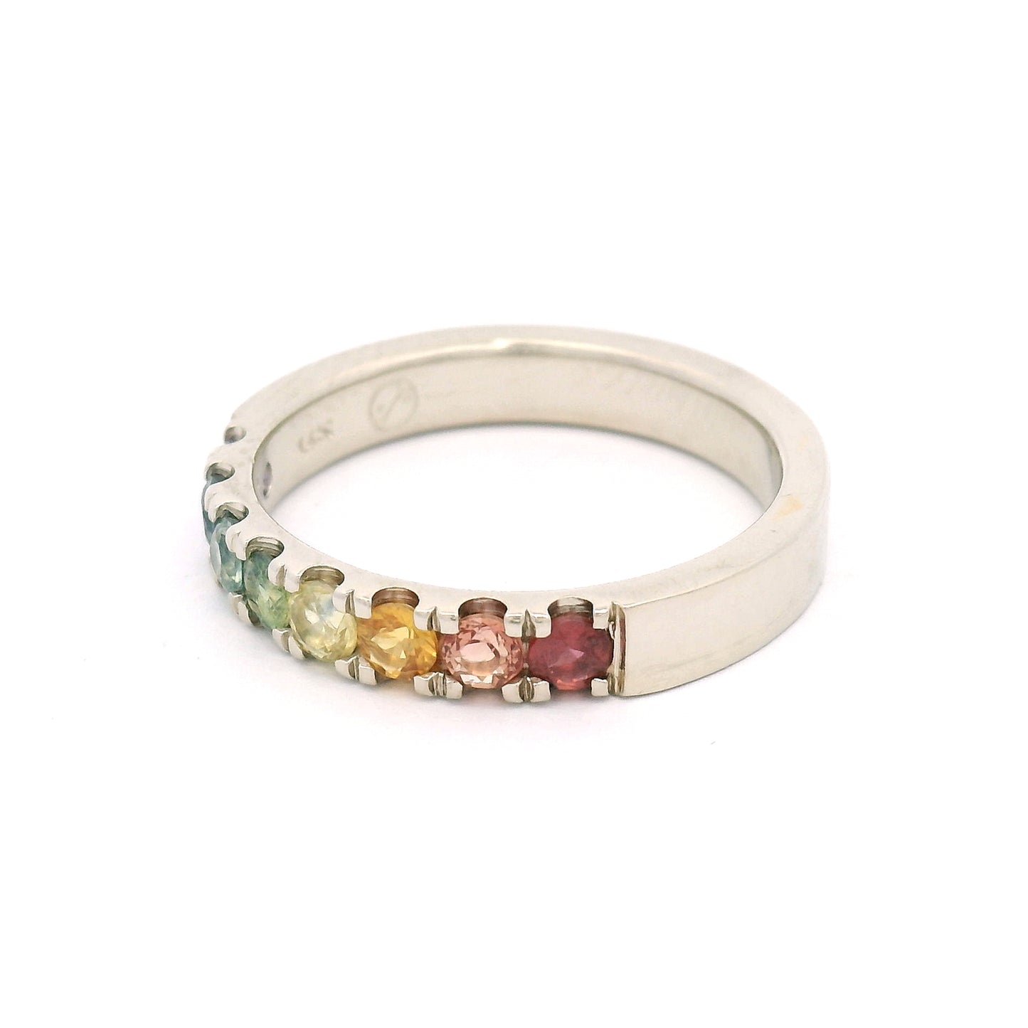 14K white gold rainbow band by Aimee Kennedy with eight 2.8mm round bead-set sapphires in rainbow colours and cut-through scalloped sides.