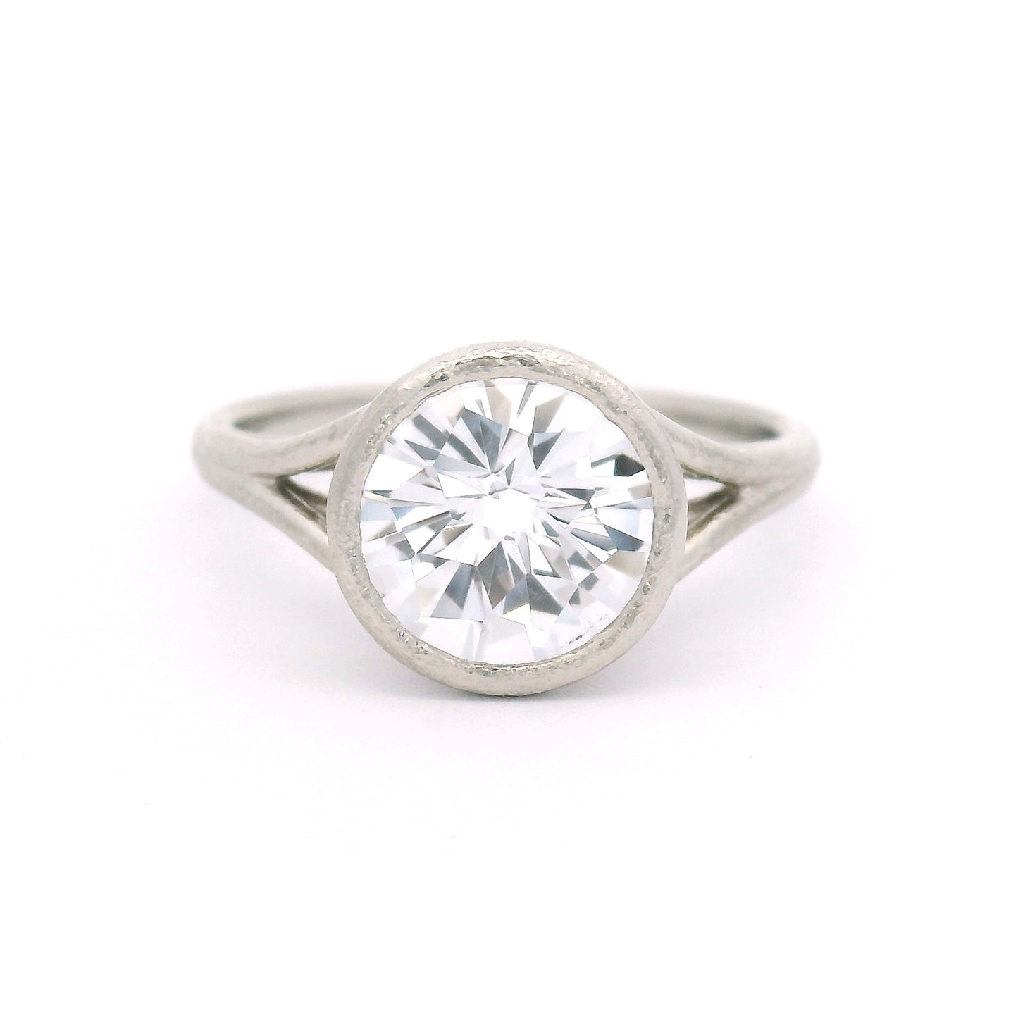 10K white gold solitaire ring featuring a bezel-set 2.57ct lab-grown round rose-cut white sapphire with a delicate organic split shank.