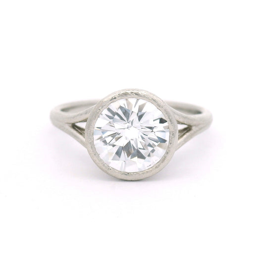 10K white gold solitaire ring featuring a bezel-set 2.57ct lab-grown round rose-cut white sapphire with a delicate organic split shank.