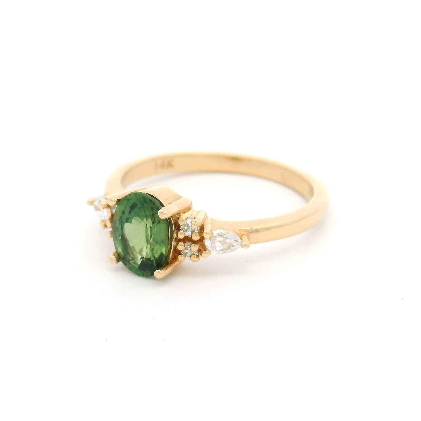14K yellow gold engagement ring featuring a claw-set natural 1.09ct oval mixed-cut green sapphire with pear-shaped and round brilliant-cut lab-grown diamond accents on a delicate 1.8mm band.