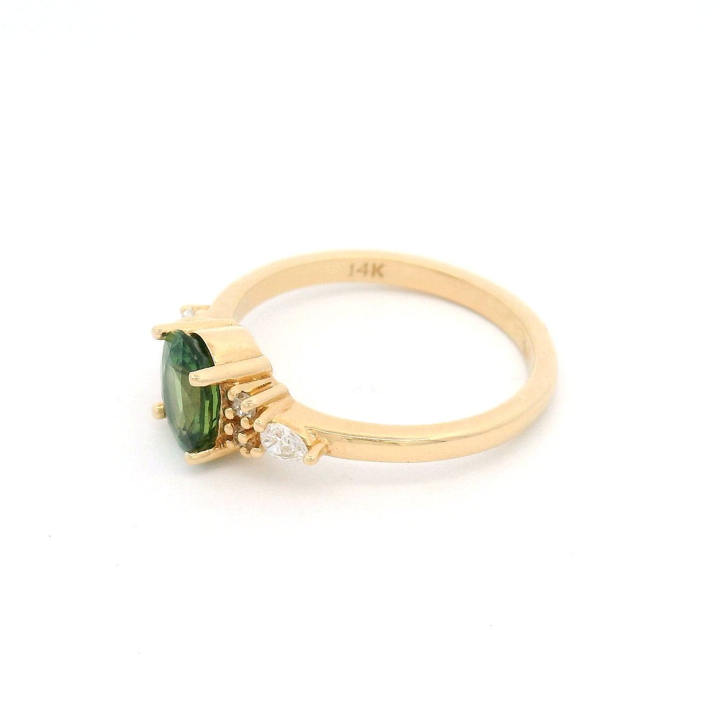 14K yellow gold engagement ring featuring a claw-set natural 1.09ct oval mixed-cut green sapphire with pear-shaped and round brilliant-cut lab-grown diamond accents on a delicate 1.8mm band.