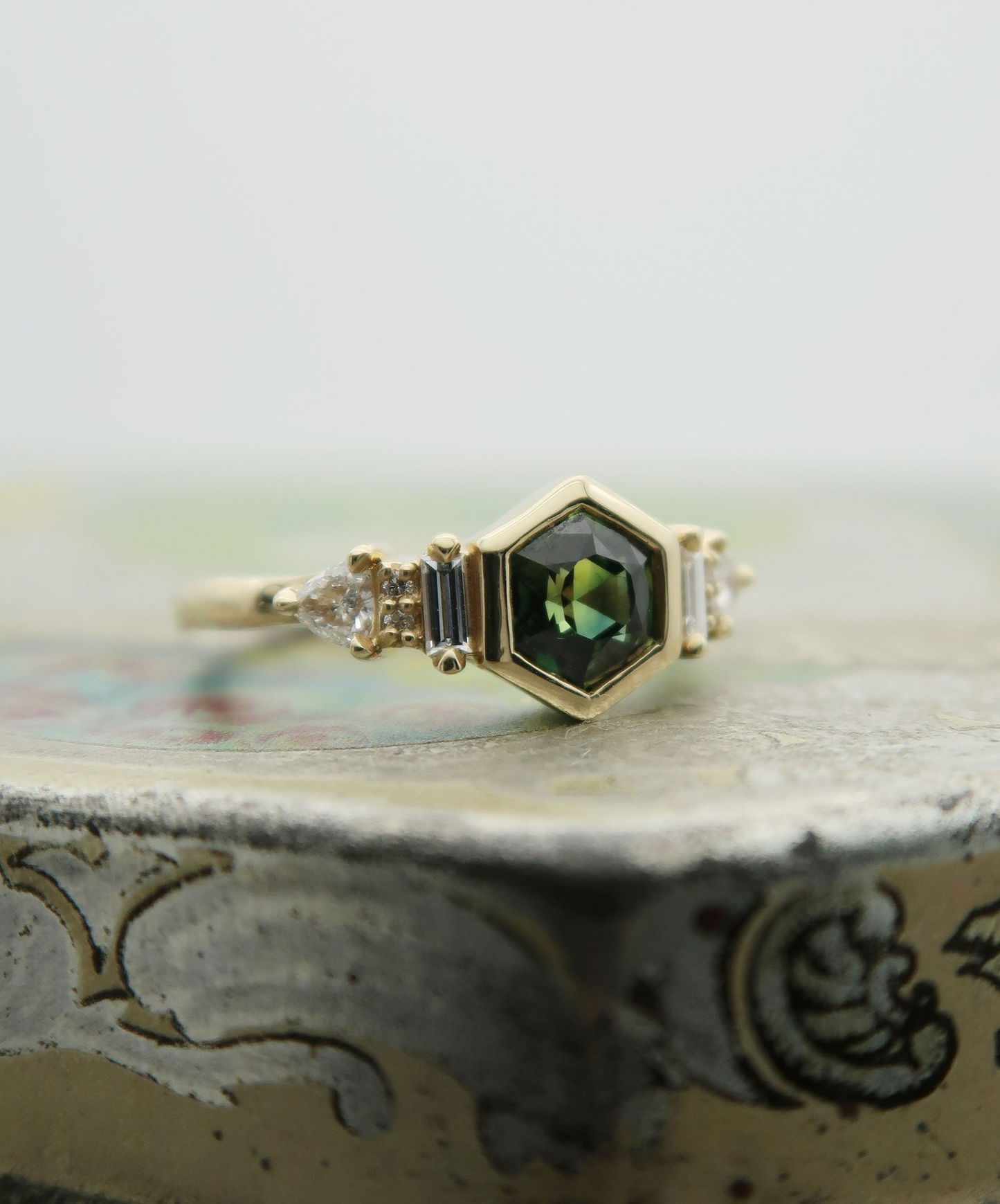 14K 0.88ct Australian green sapphire lab diamond accent engagement ring.  Displayed on a tile.
