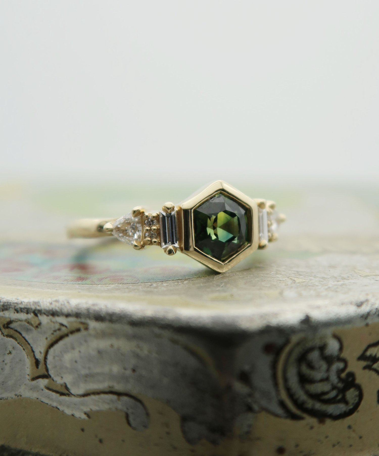 14K 0.88ct Australian green sapphire lab diamond accent engagement ring.  Displayed on a tile.