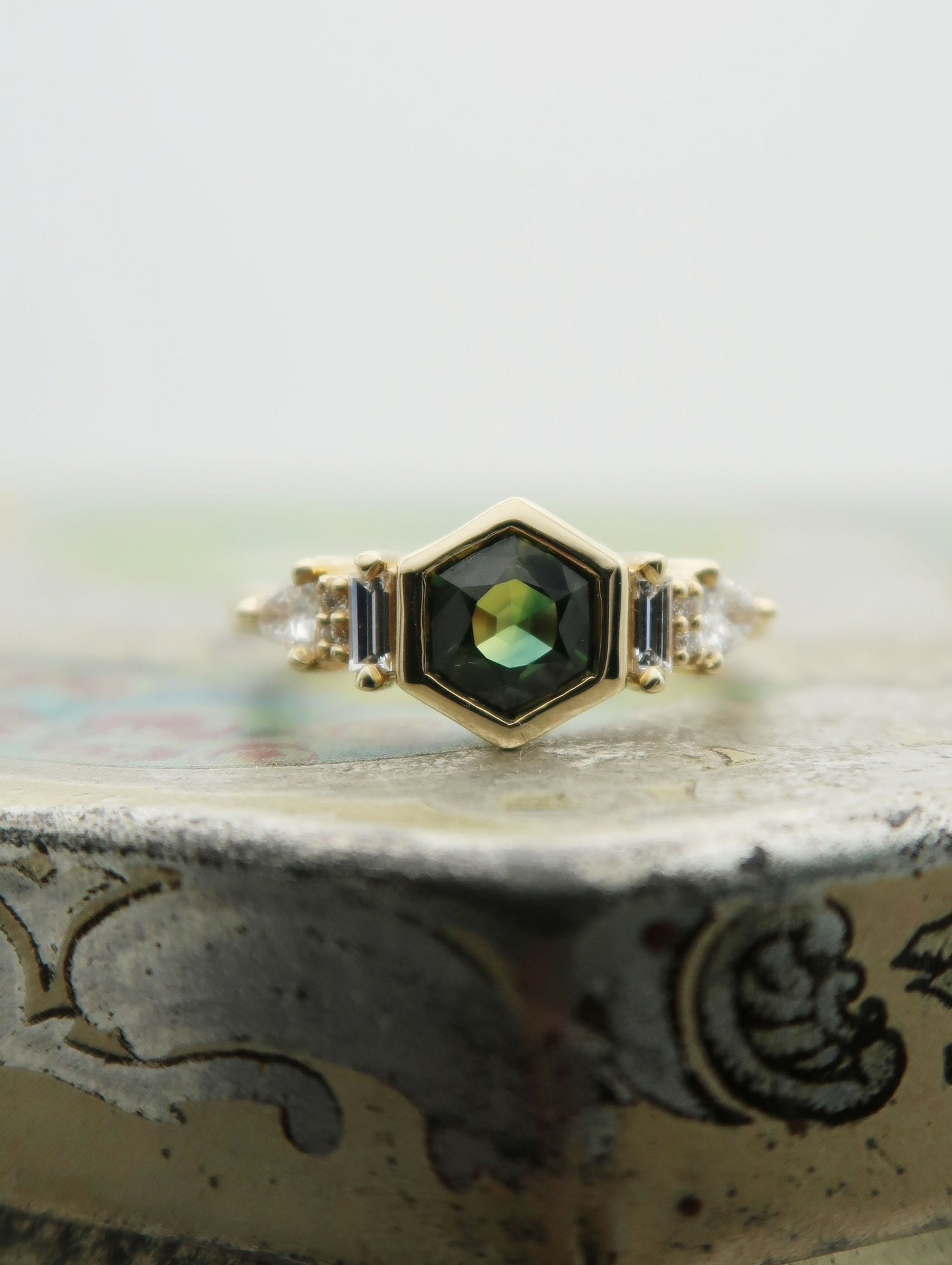 14K 0.88ct Australian green sapphire lab diamond accent engagement ring.  Displayed on a tile, focusing on the centre gem.